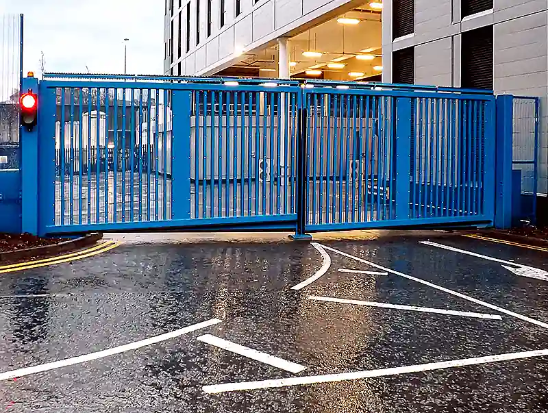 Blue LPS 1175 Platinum Double Hinged Gate securing a controlled vehicle entrance at a high-security facility.