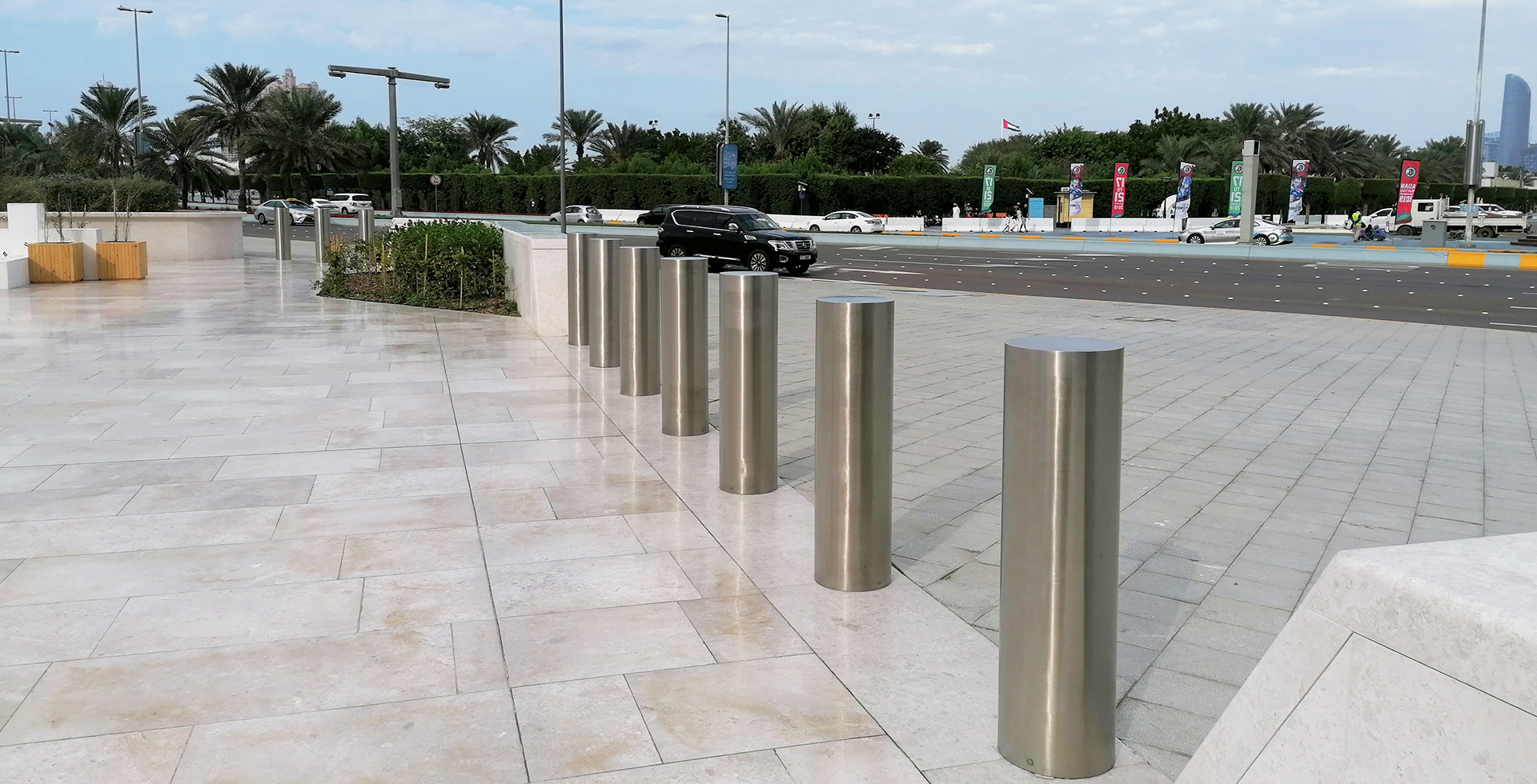 A city street with crash-rated bollards protecting a pedestrian area