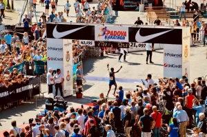 Crowded marathon finish line with runners and spectators, highlighting the importance of crowd control and security at major sporting events.