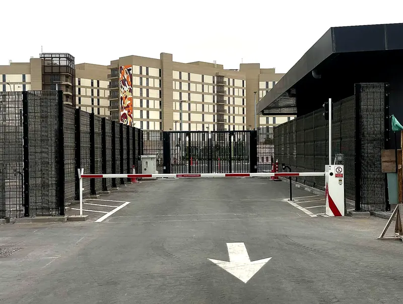 Security barriers and controlled vehicle access gates protecting a secure facility entrance in the UAE.