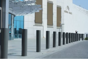 Crash rated bollards protecting a mall entrance from vehicle intrusion while maintaining safe pedestrian access.