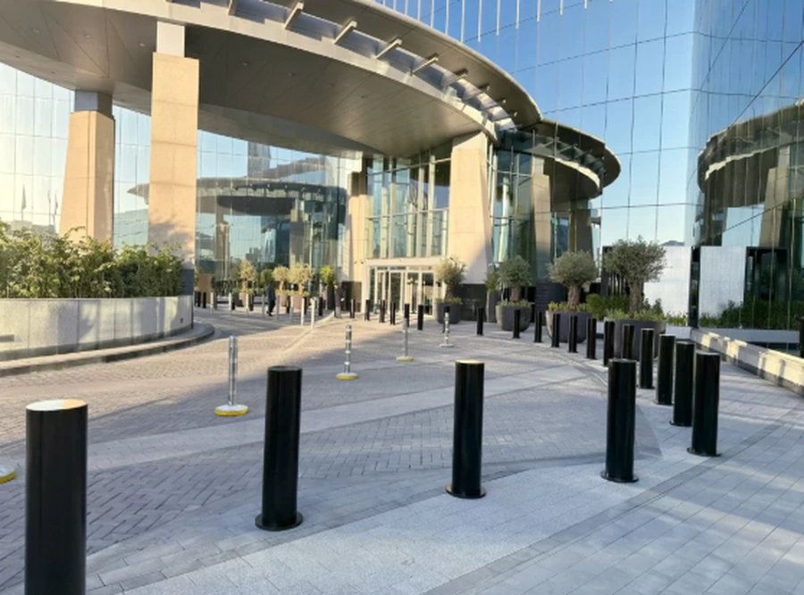 High-security bollards installed at a building entrance to protect pedestrians and control vehicle access.