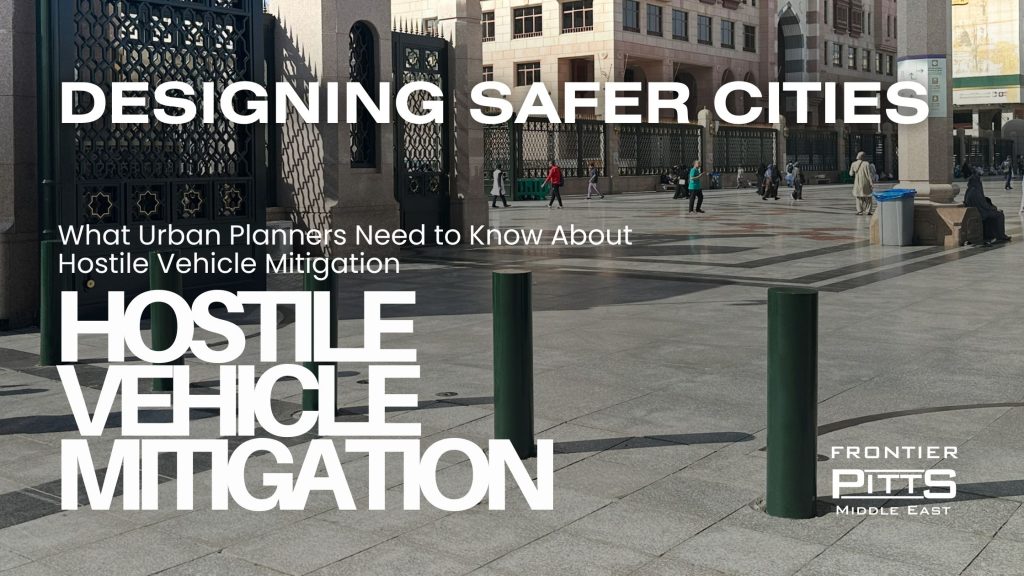Urban plaza with security bollards in the foreground, pedestrians walking near a gated building. Overlay text reads: 'Designing Safer Cities – What Urban Planners Need to Know About Hostile Vehicle Mitigation' with Frontier Pitts Middle East logo