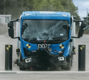 Heavy truck crash-test impact against a PAS 68-rated road blocker, demonstrating hostile vehicle mitigation barrier performance