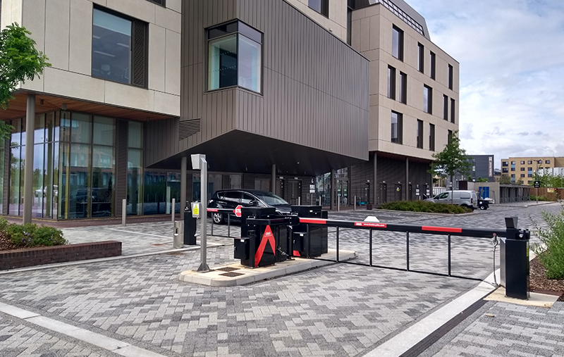 Crash rated road blocker barrier securing restricted government facility entrance